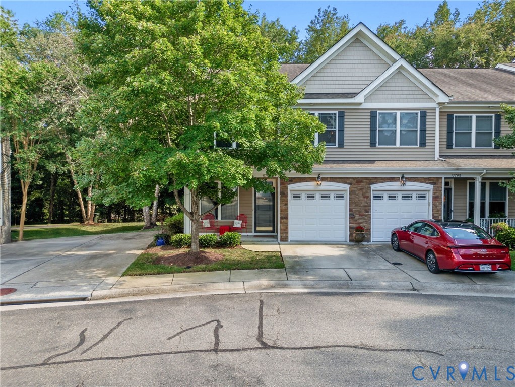 13712 Woodbridge Crossing Way Midlothian, VA 23112 - Photo 33 of 33 a front view of a house with trees and cars parked