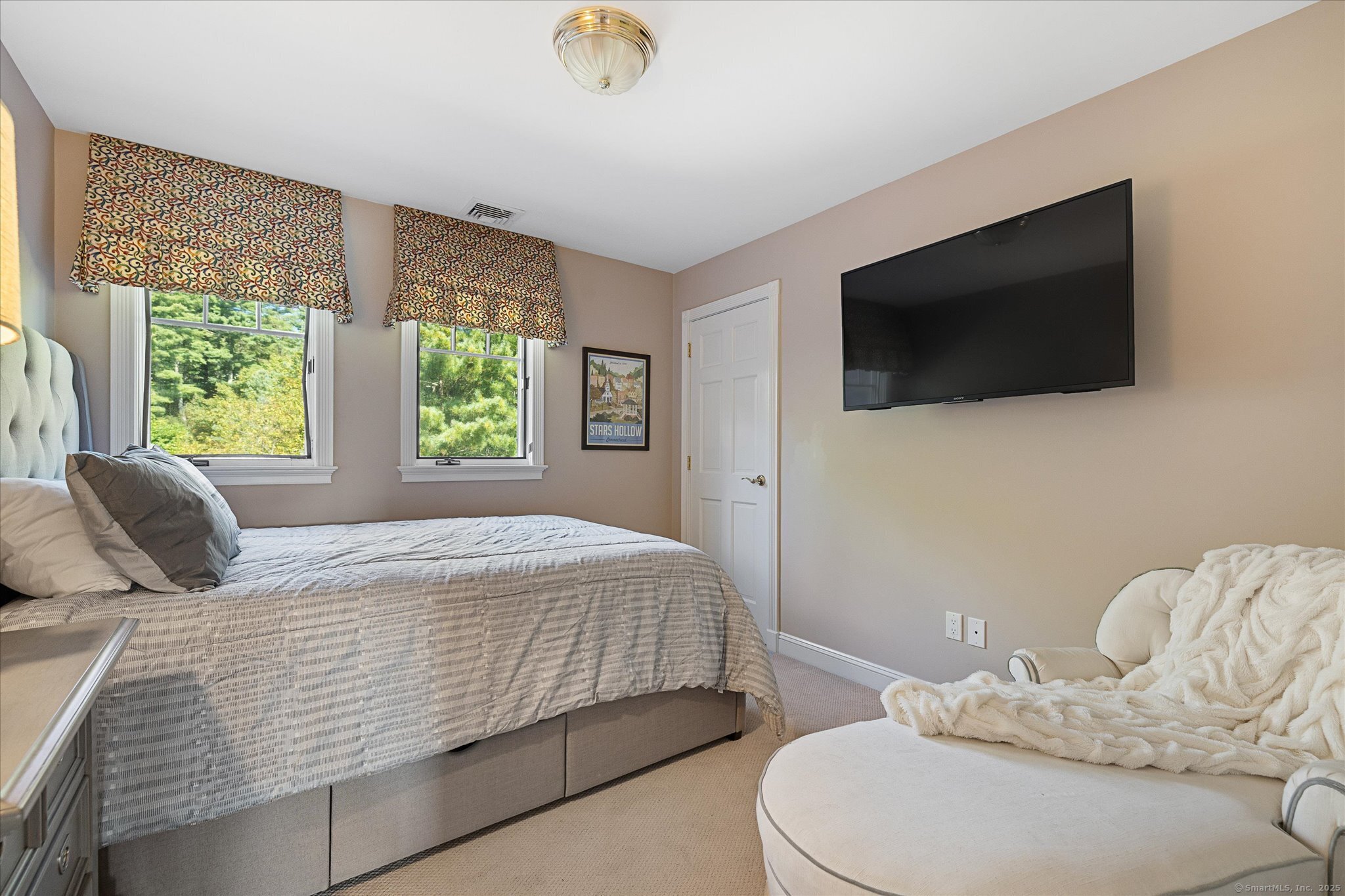 21-40 Howard Road Union, CT 06076 - Photo 17 of 40 a bedroom with a bed a flat screen tv and a large window