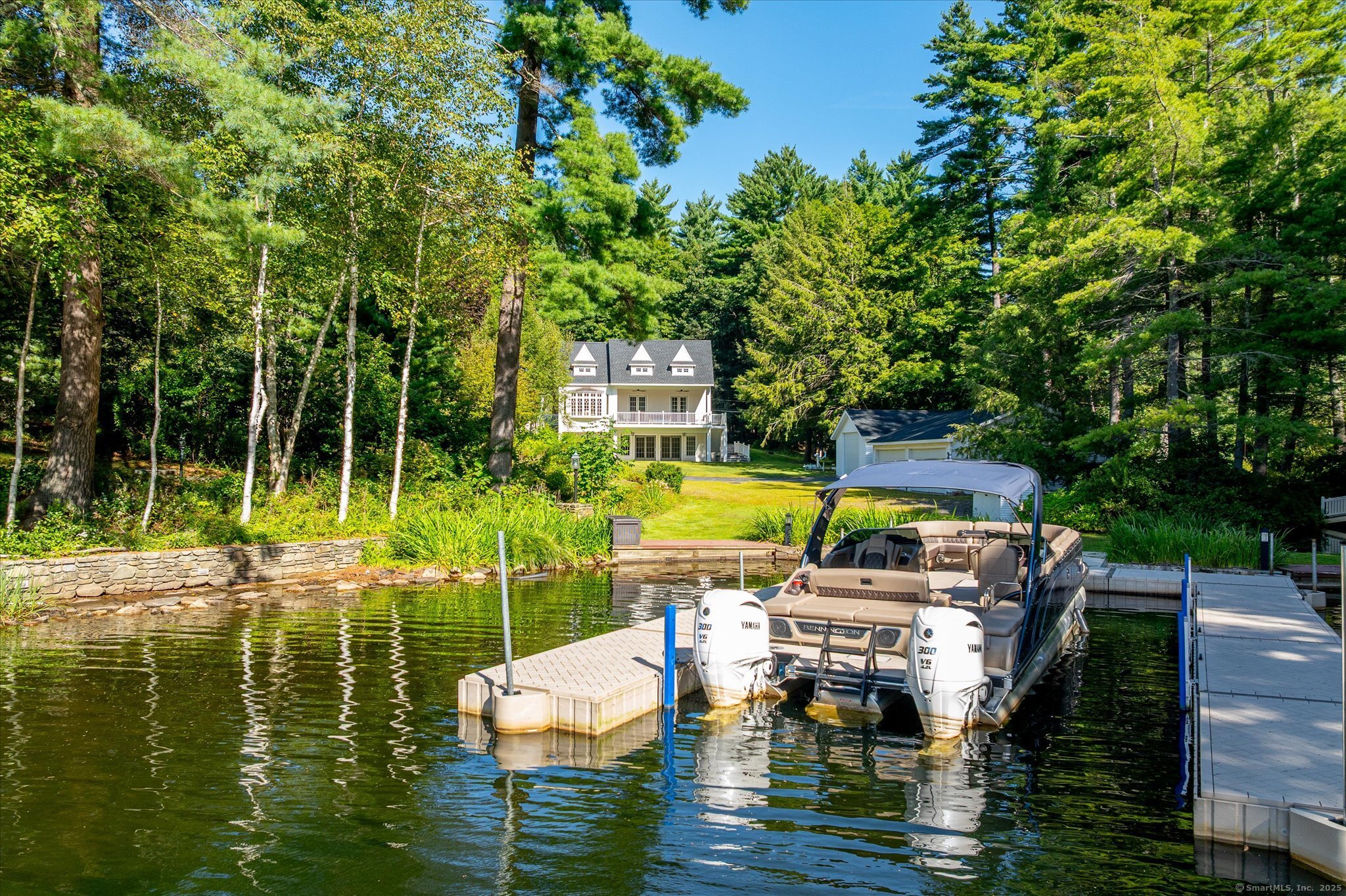 21-40 Howard Road Union, CT 06076 - Photo 20 of 40 a view of a swimming pool with lawn chairs and a dining table under an umbrella