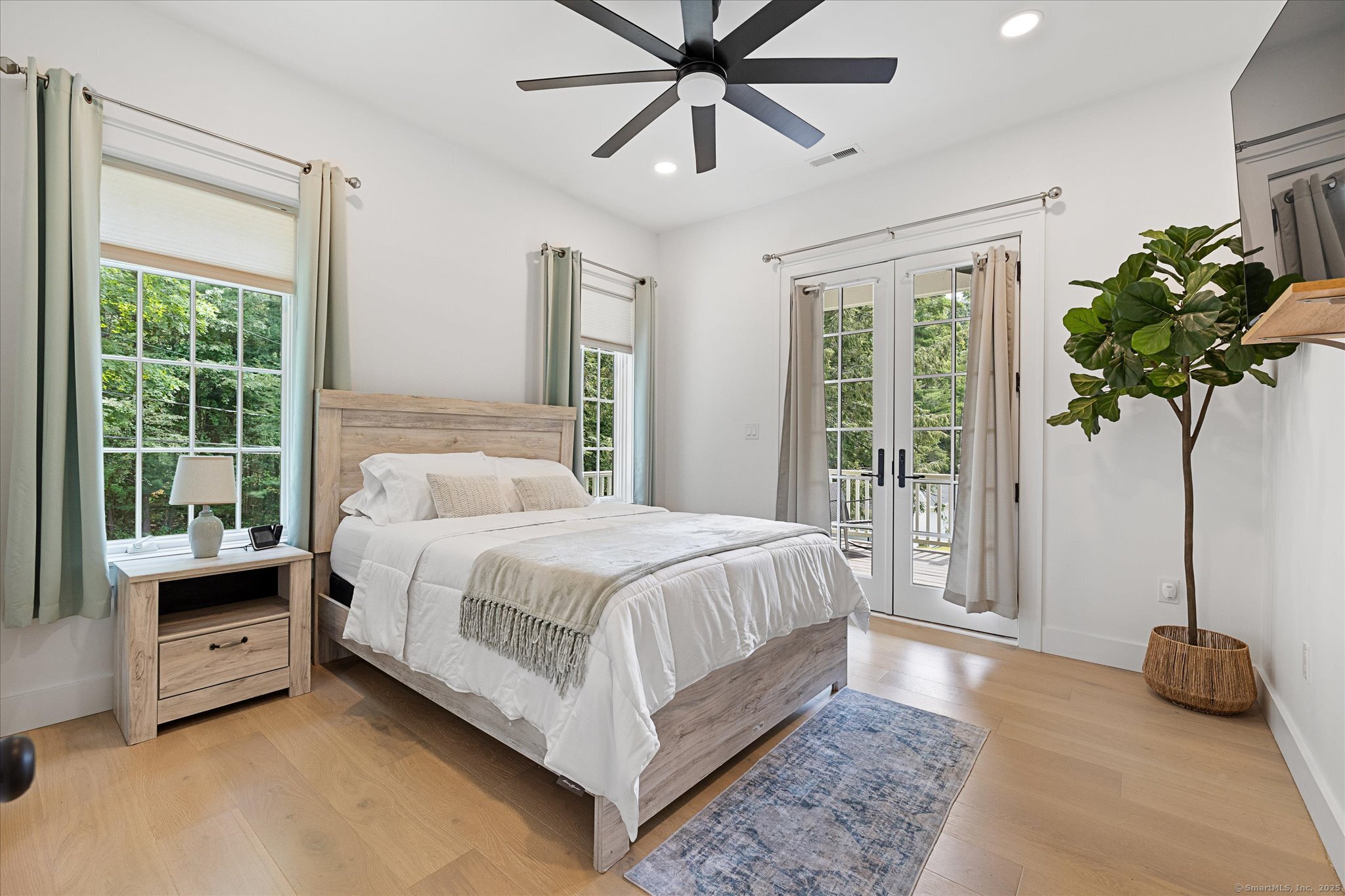 21-40 Howard Road Union, CT 06076 - Photo 28 of 40 a bedroom with a bed a chandelier and a large window