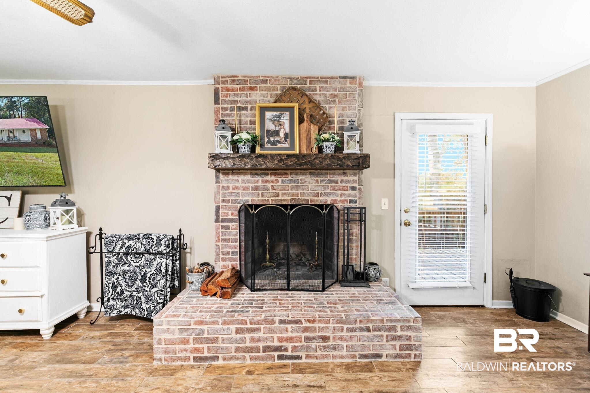 4 Rally Road Spanish Fort, AL 36527 - Photo 12 of 41 Living area with crown molding, light wood-type flooring, and a fireplace