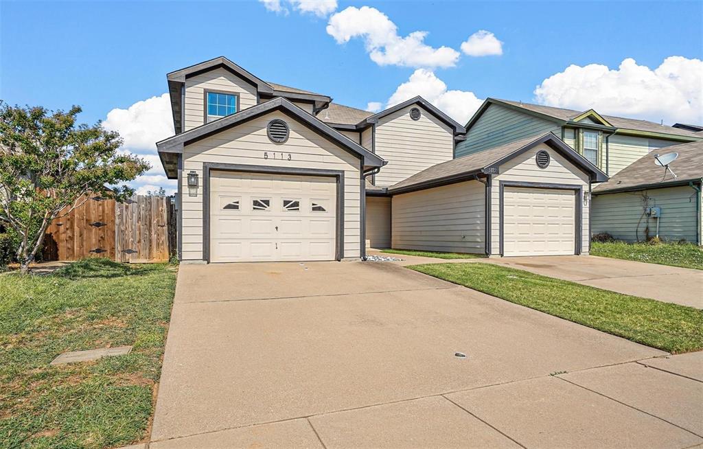 5113 Mountain Spring Trail Fort Worth, TX 76123 - Photo 2 of 35 a front view of a house with a yard and garage
