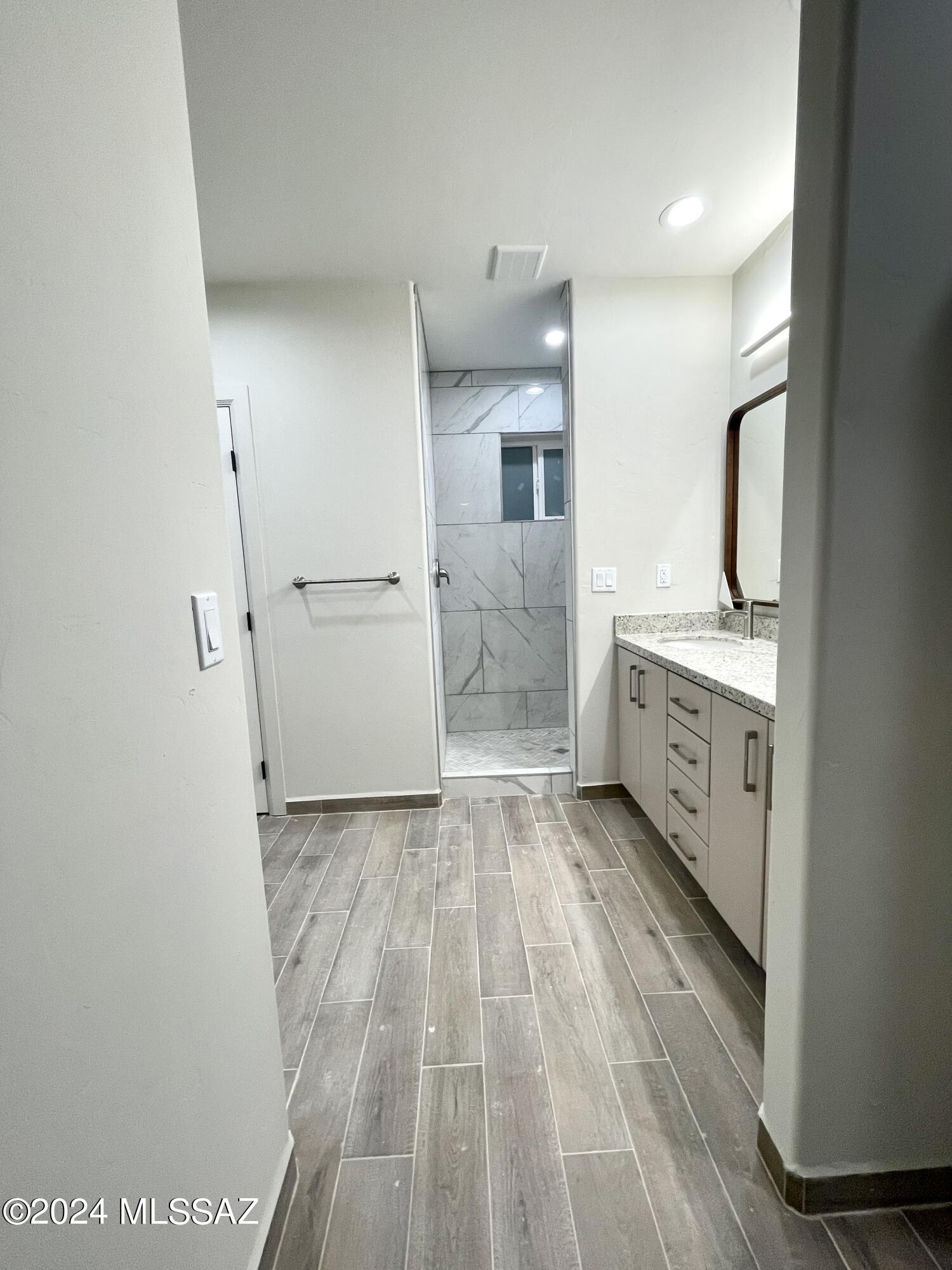 1049 Camino Estrella Rio Rico, AZ 85648 - Photo 14 of 28 a view of a kitchen with white cabinets and wooden floor