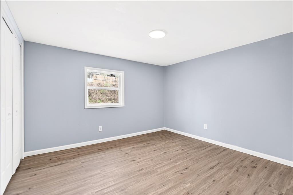 93 Old 51 Road Perryopolis, PA 15473 - Photo 25 of 44 a view of an empty room with wooden floor