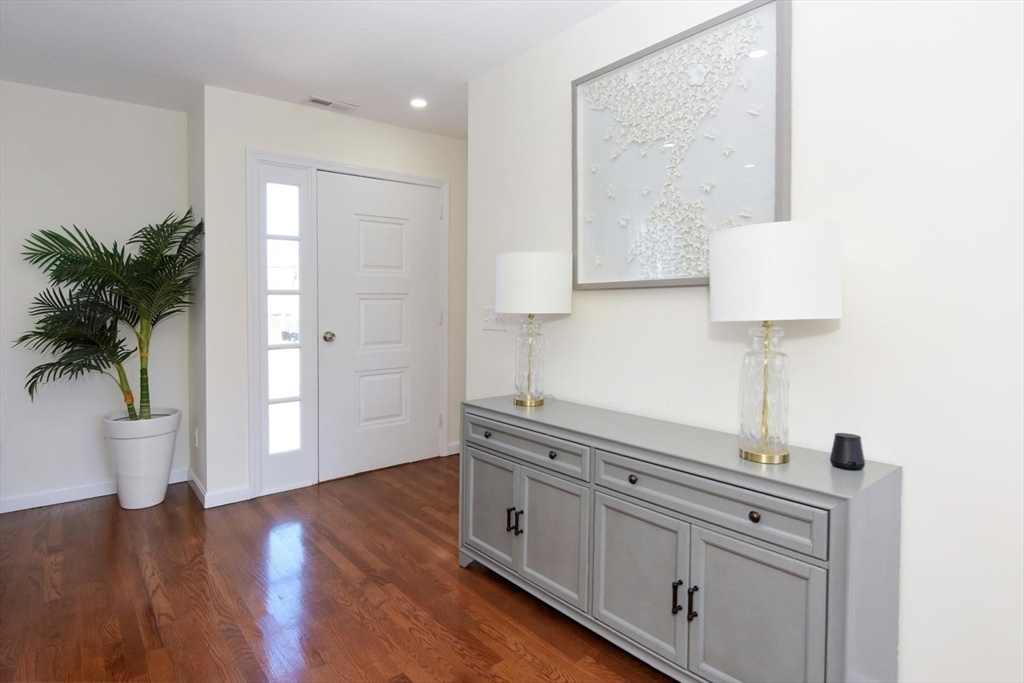 7 Erhardt Terrace Methuen, MA 01844 - Photo 11 of 24 a hallway with view of wooden floor and chair