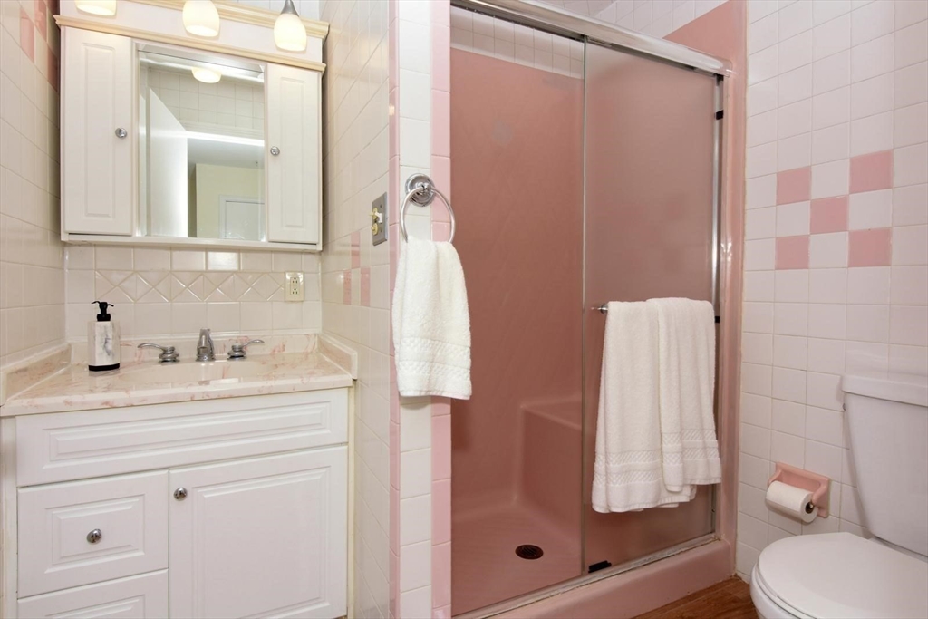 7 Erhardt Terrace Methuen, MA 01844 - Photo 18 of 24 a bathroom with a granite countertop sink vanity mirror and shower