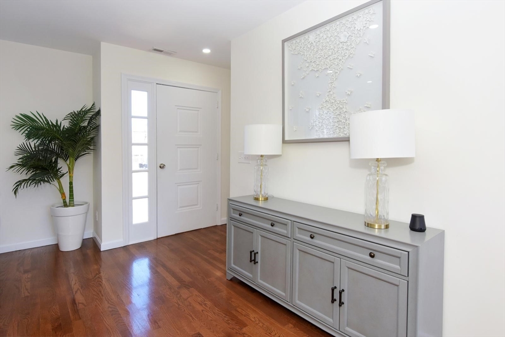 7 Erhardt Terrace Methuen, MA 01844 - Photo 22 of 24 a hallway with view of wooden floor and chair