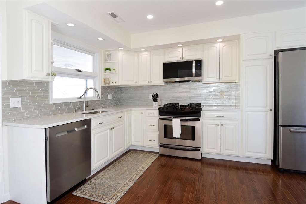 7 Erhardt Terrace Methuen, MA 01844 - Photo 3 of 24 a kitchen with a sink stove and refrigerator