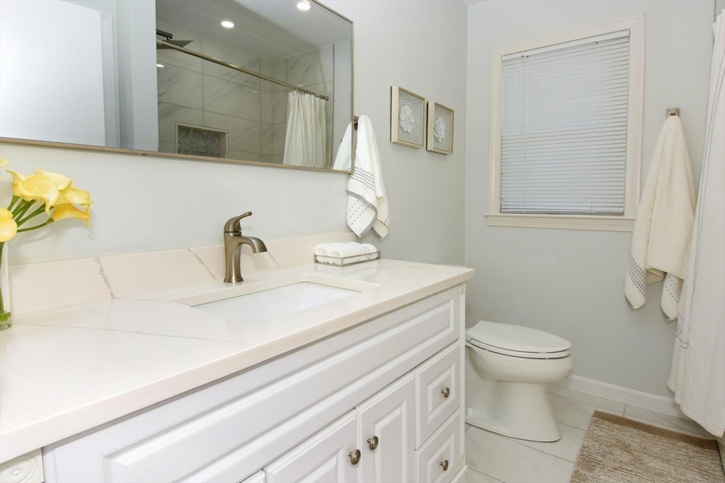 7 Erhardt Terrace Methuen, MA 01844 - Photo 6 of 24 a bathroom with a sink a toilet and mirror