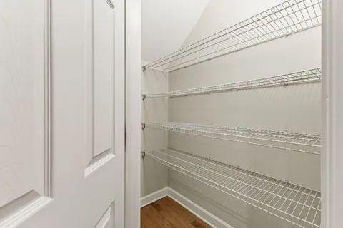 a view of walk in closet with empty racks