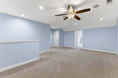 a view of an empty room with a ceiling fan