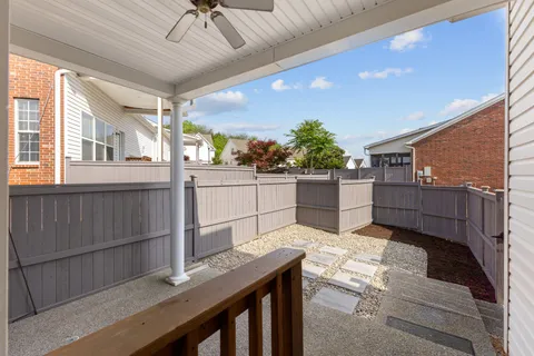 a view of a house with backyard and wooden fence
