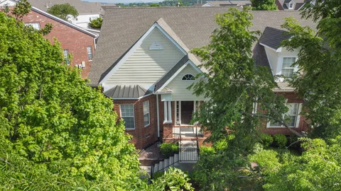 an aerial view of a house with garden space and street view