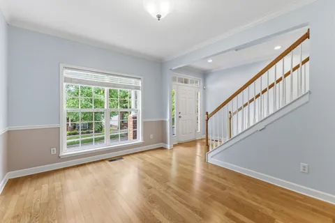 a view of an entryway with wooden floor