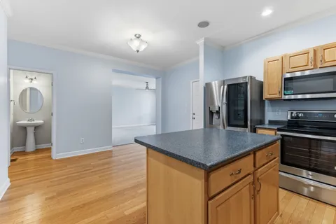 a kitchen with stainless steel appliances granite countertop a stove refrigerator and microwave