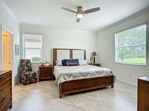 a spacious bedroom with a bed and a chandelier