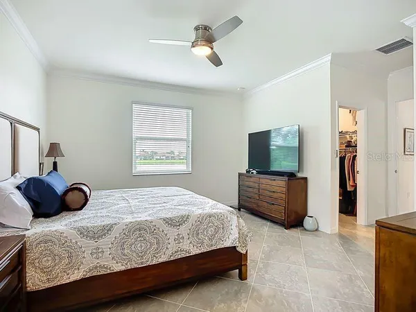 a bedroom with a bed and a television