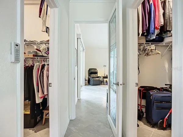 a view of walk in closet with clothes and shoes