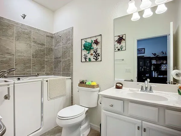 a bathroom with a sink a toilet and a mirror