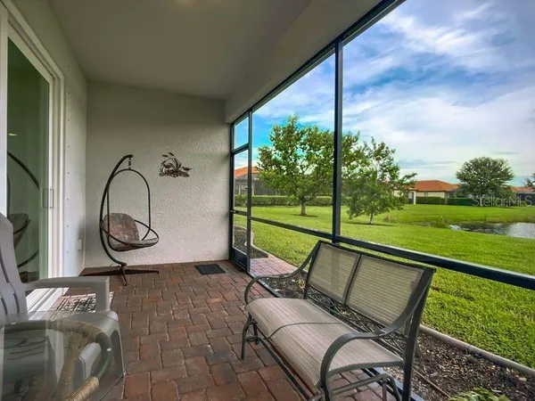 a view of swimming pool with a lounge chairs and a backyard