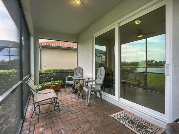 a living room with a floor to ceiling window and a table
