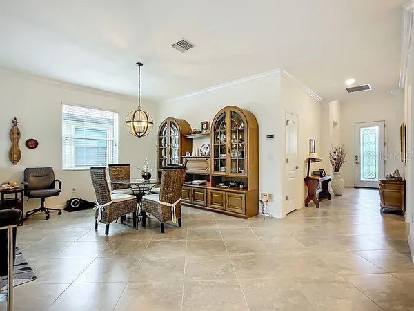 a living room with furniture a dining table with rug floor and a large window