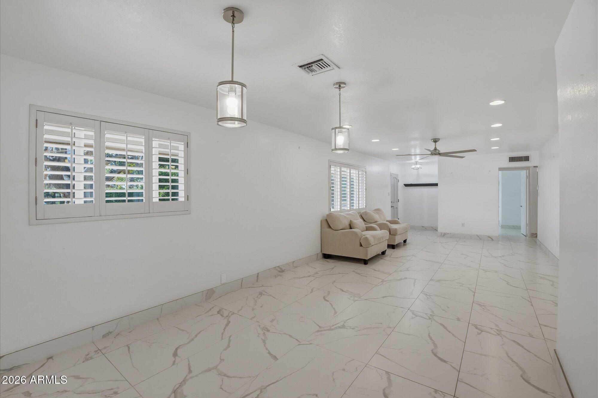 1532 West Loma Lane Phoenix, AZ 85021 - Photo 7 of 19 a large room with chandelier fan and windows