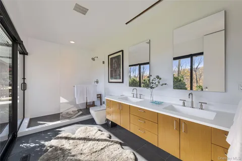 a spacious bathroom with a double vanity sink and a mirror