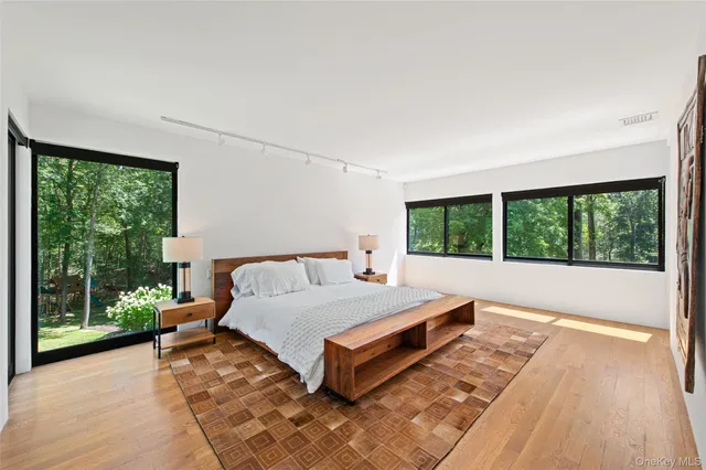 a bed sitting in a bedroom next to a window