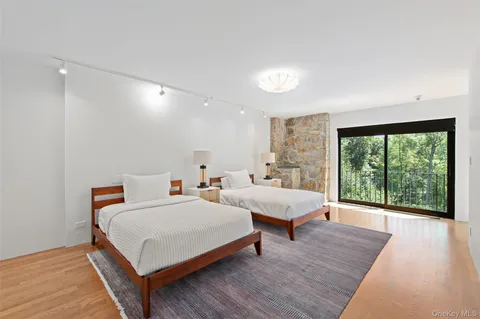 a bedroom with two beds and a large window