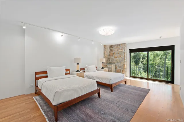 a bedroom with two beds and a large window