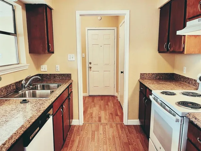 a kitchen with a sink stove and cabinets