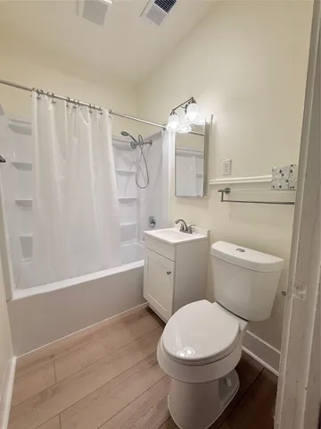 a bathroom with a toilet sink and shower