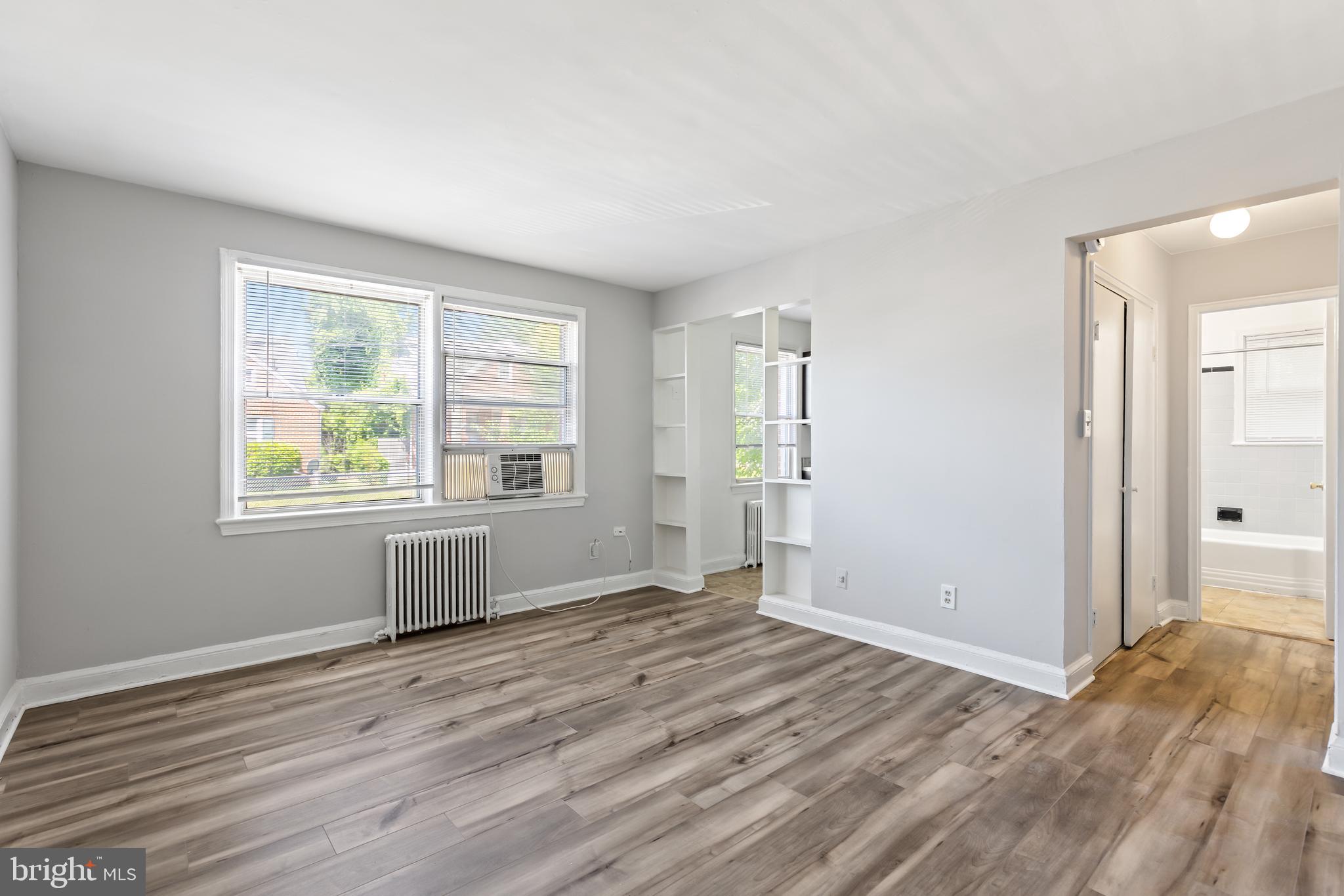 3320 11th Place Southeast, Unit 101 Washington, DC 20032 - Photo 3 of 8 a view of empty room with wooden floor and fan