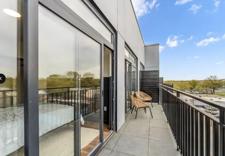 a view of a balcony with furniture and city view