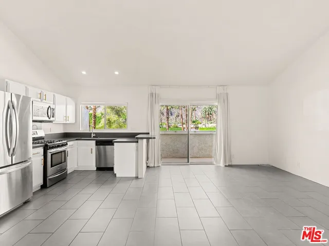 a kitchen with a refrigerator stove and microwave