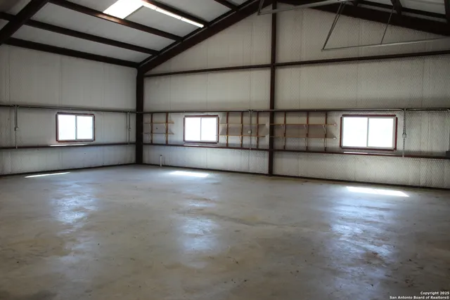 a backyard of a house with outdoor seating and trees