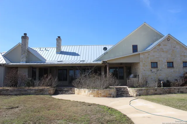a view of a house with backyard porch and sitting area