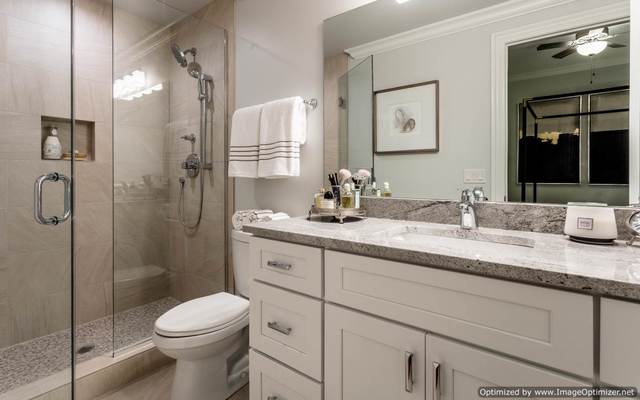 Undisclosed Address Chicago, IL 60607 - Photo 12 of 16 a bathroom with a granite countertop sink toilet and shower
