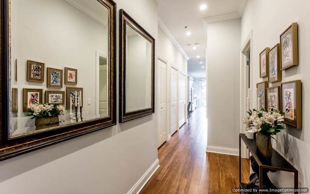Undisclosed Address Chicago, IL 60607 - Photo 14 of 16 a view of a hallway with a large mirror on a dresser