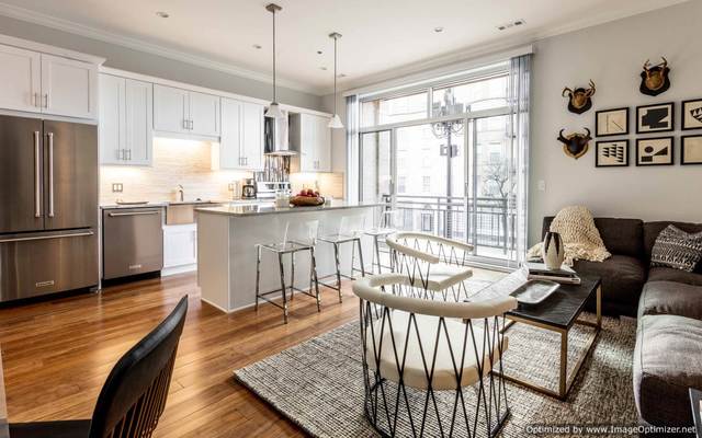 Undisclosed Address Chicago, IL 60607 - Photo 2 of 16 a kitchen with granite countertop lots of white furniture wooden floor and stainless steel appliances