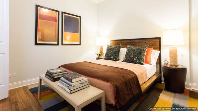 Undisclosed Address Chicago, IL 60607 - Photo 10 of 16 a bedroom with a bed and a night stand