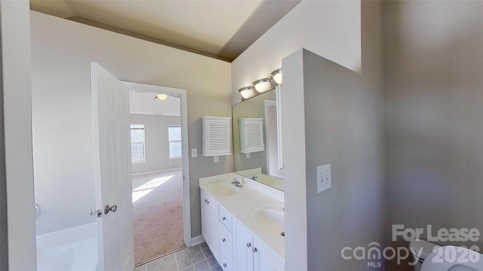 7236 Rock Island Road Charlotte, NC 28278 - Photo 8 of 11 a bathroom with a tub sink and mirror