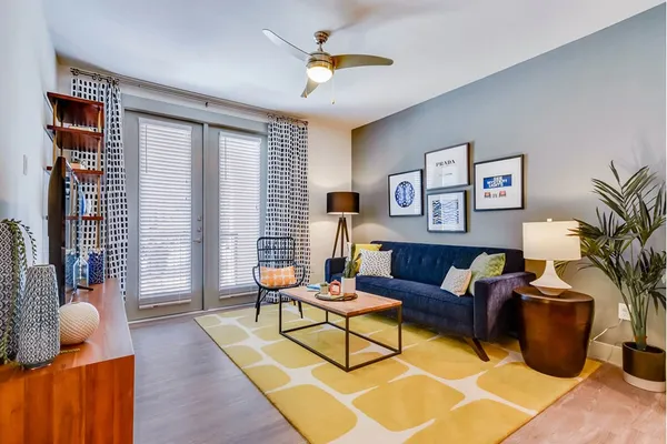 a living room with furniture and wooden floor