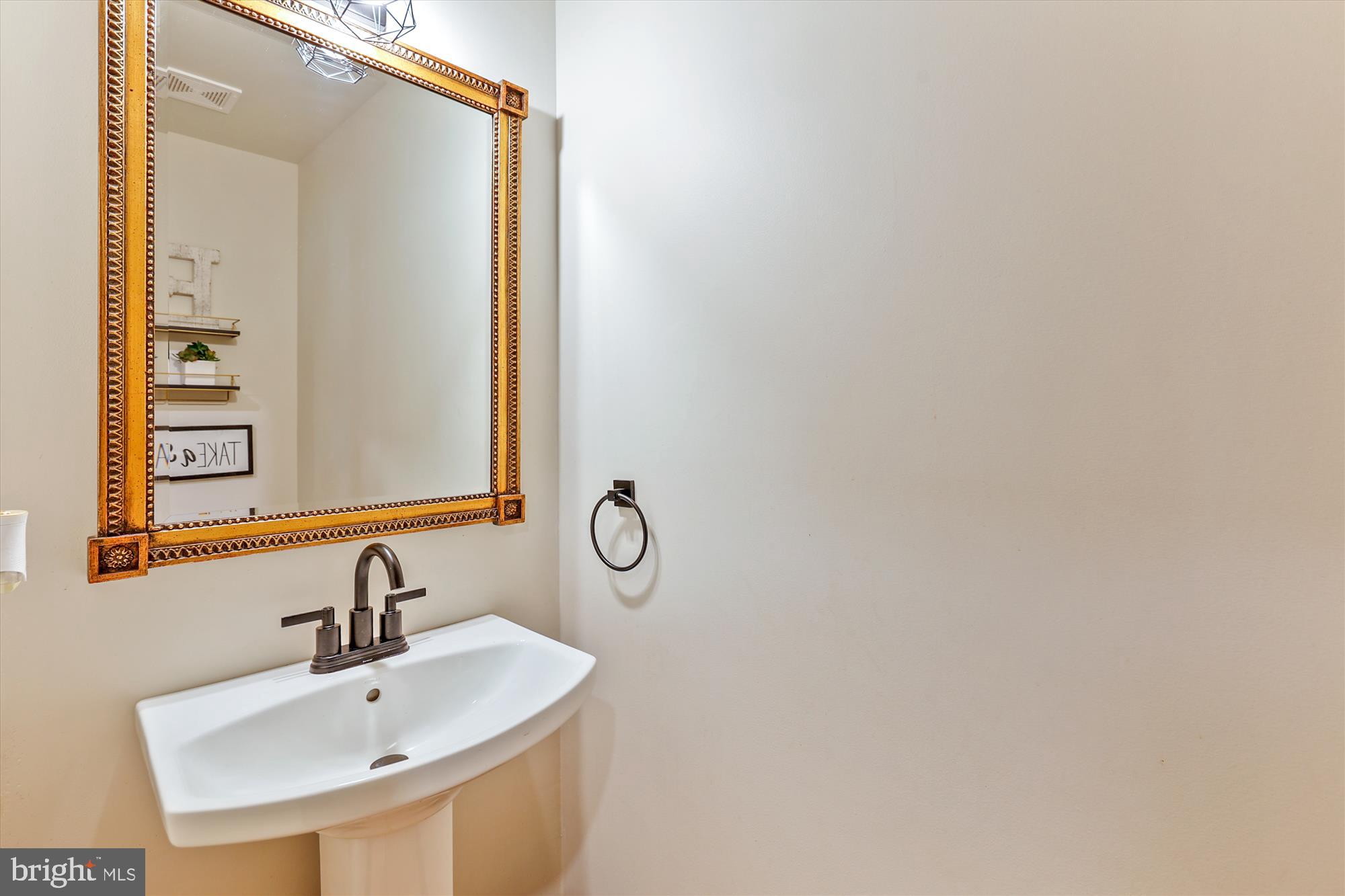 7643 Old Receiver Road Frederick, MD 21702 - Photo 32 of 82 a bathroom with a sink and a mirror
