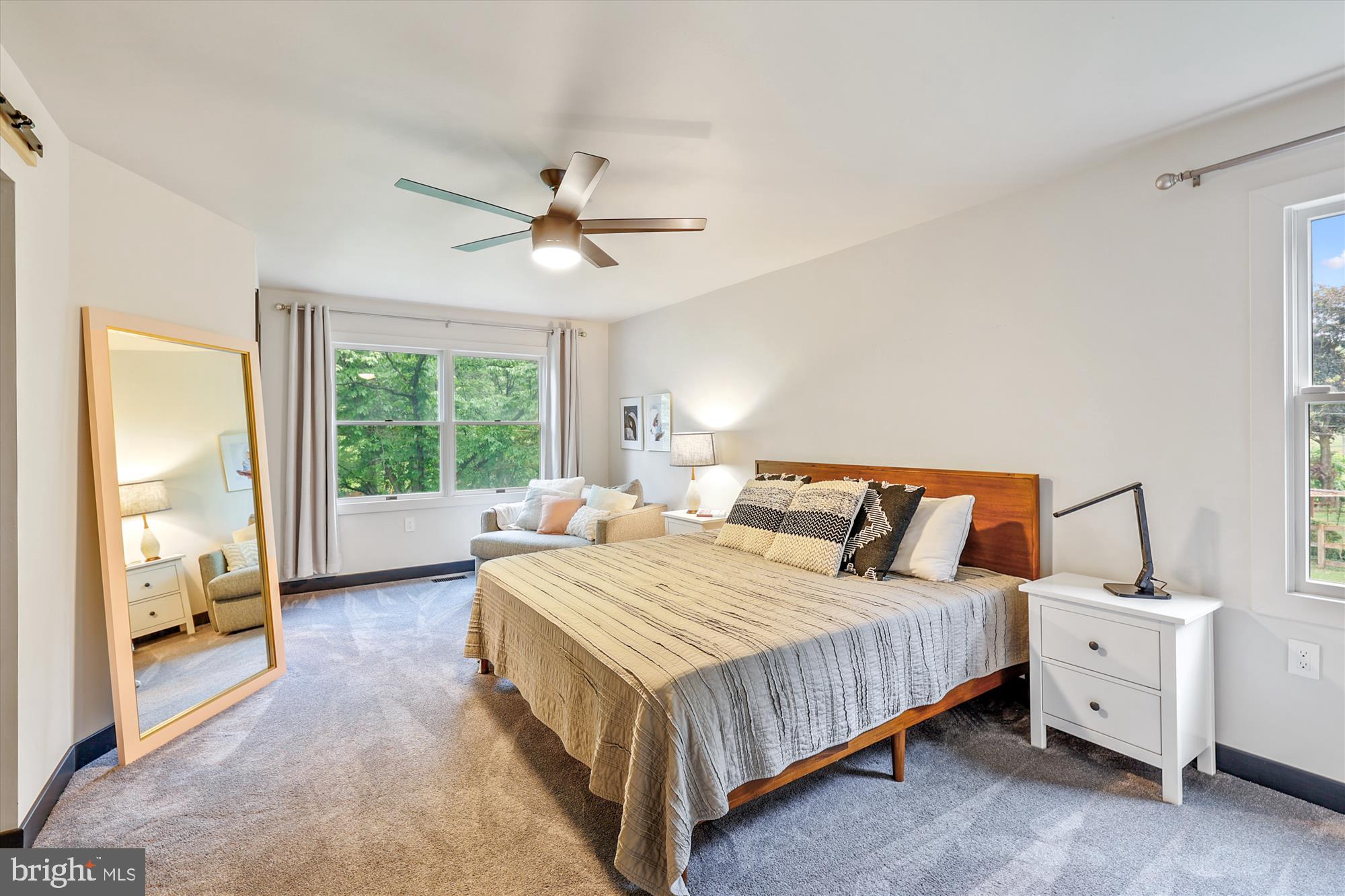 7643 Old Receiver Road Frederick, MD 21702 - Photo 33 of 82 a bedroom with a large bed and a chandelier