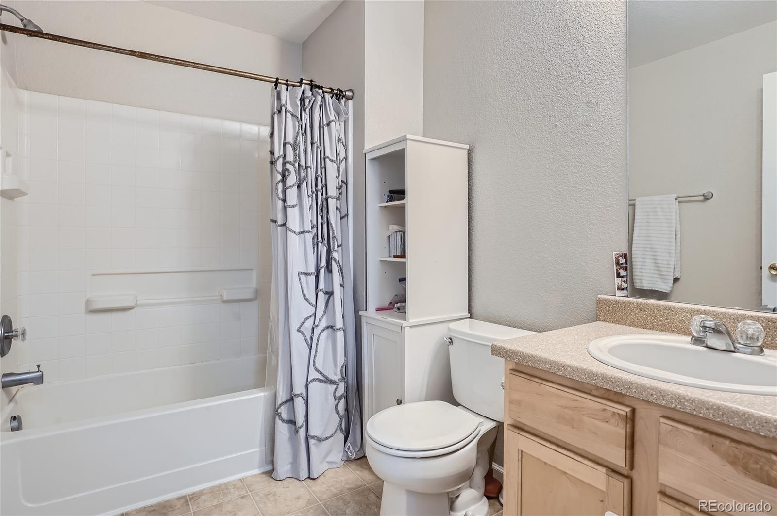 4725 Andes Street Denver, CO 80249 - Photo 15 of 27 a bathroom with a sink toilet and shower