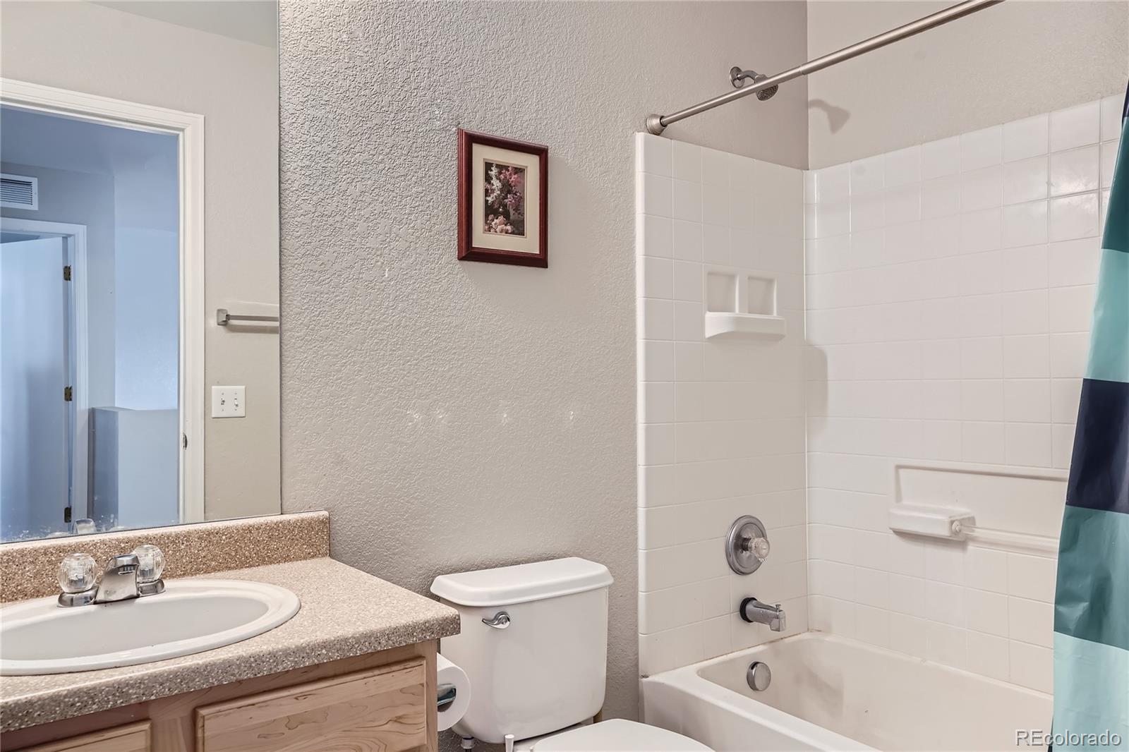 4725 Andes Street Denver, CO 80249 - Photo 17 of 27 a bathroom with a sink a toilet and shower