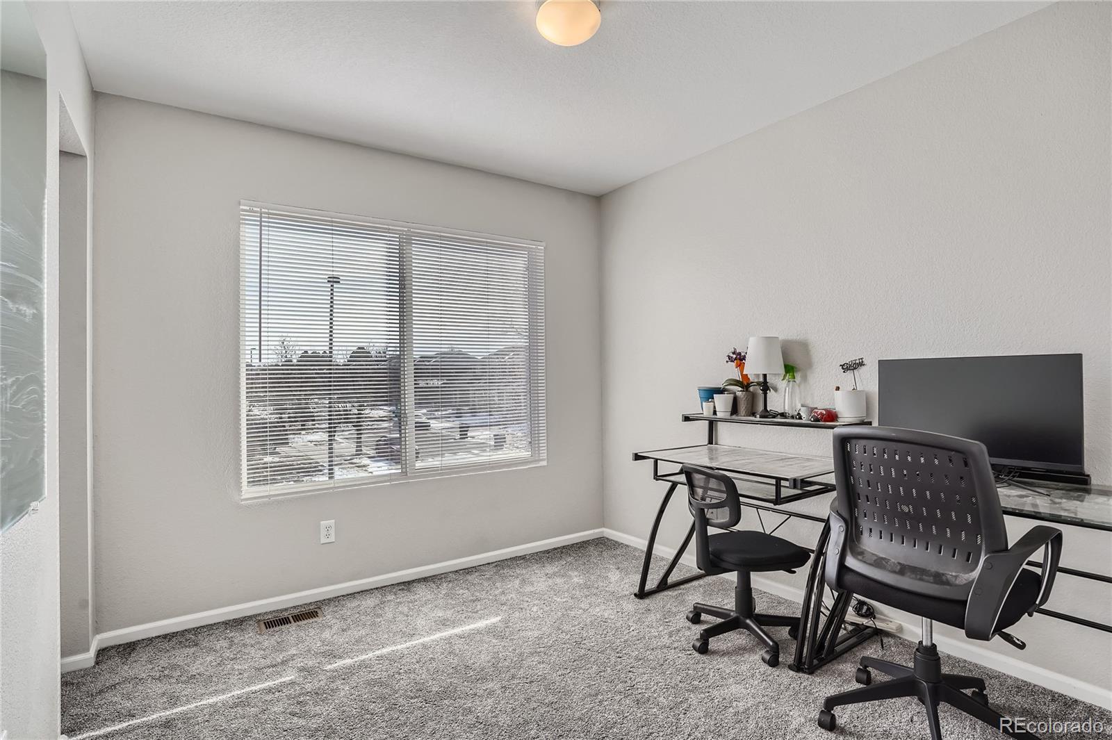 4725 Andes Street Denver, CO 80249 - Photo 18 of 27 a workspace with furniture and window