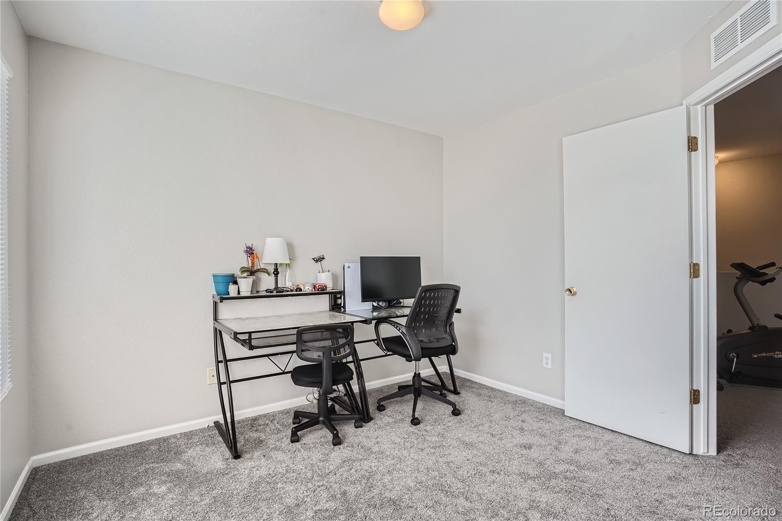 4725 Andes Street Denver, CO 80249 - Photo 19 of 27 a view of a workspace with furniture
